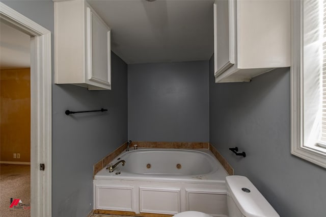 bathroom featuring a washtub and toilet