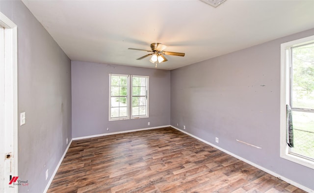 spare room with dark hardwood / wood-style flooring and ceiling fan