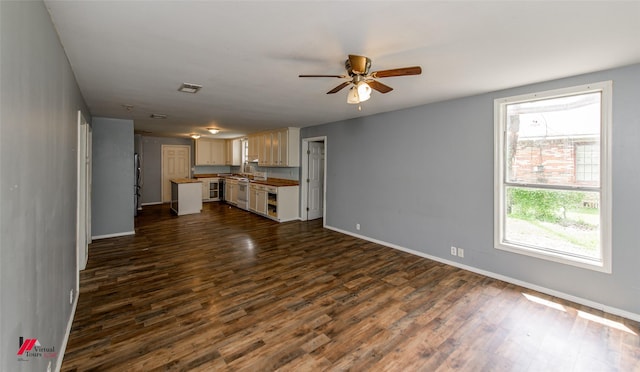 unfurnished living room featuring ceiling fan and dark hardwood / wood-style flooring