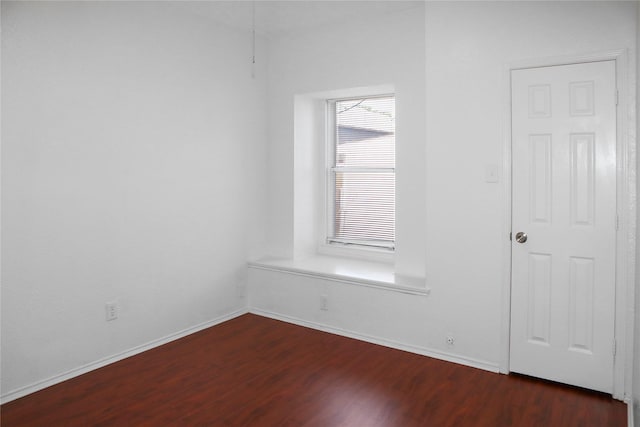 spare room with dark hardwood / wood-style flooring