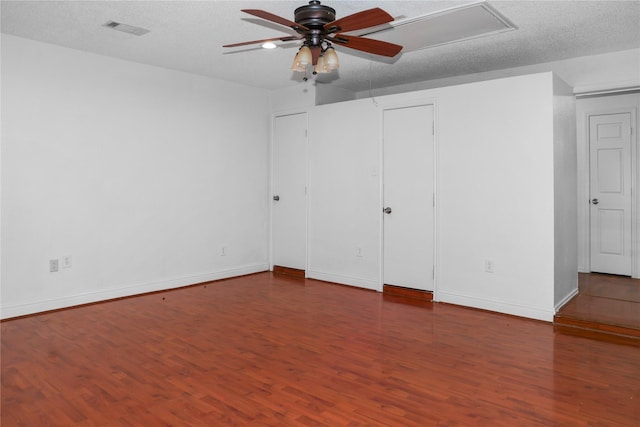 unfurnished bedroom featuring dark wood-type flooring and a textured ceiling