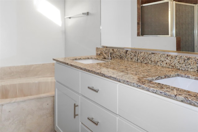 bathroom with vanity and a washtub