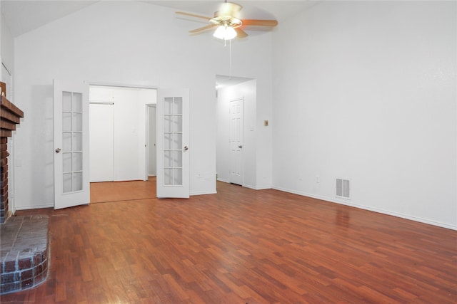 unfurnished living room with french doors, high vaulted ceiling, dark hardwood / wood-style floors, ceiling fan, and a fireplace