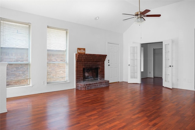 unfurnished living room with dark wood-type flooring, plenty of natural light, a fireplace, and french doors