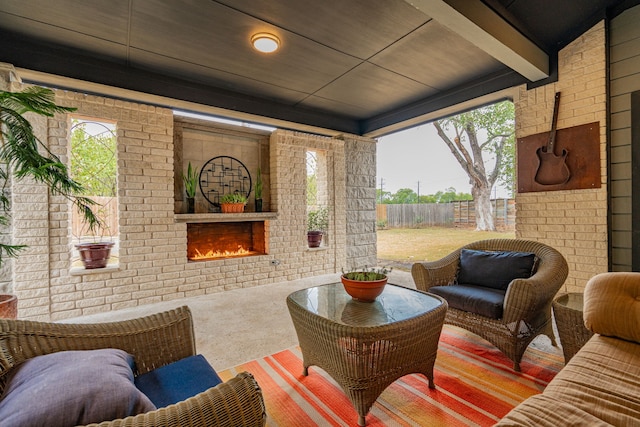 view of patio with an outdoor living space with a fireplace