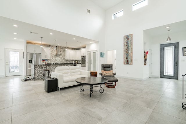 tiled living room featuring a high ceiling