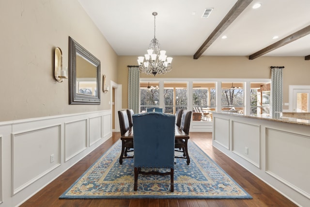 dining space with a notable chandelier, dark wood-type flooring, and beamed ceiling