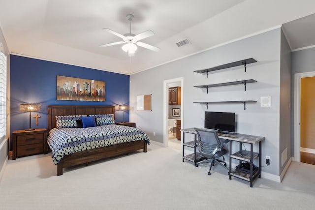 bedroom with ensuite bath, crown molding, ceiling fan, a tray ceiling, and light colored carpet