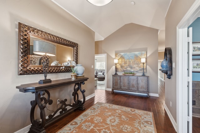 hall with lofted ceiling and dark hardwood / wood-style floors