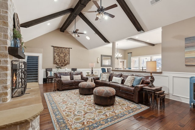 living room featuring dark wood-type flooring, a fireplace, high vaulted ceiling, and beam ceiling