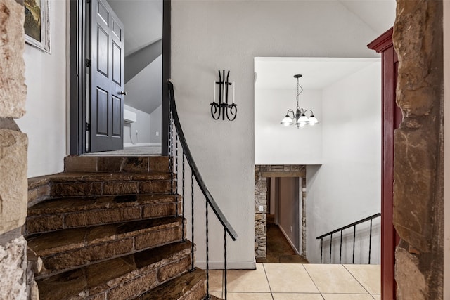 stairs featuring a notable chandelier and tile patterned floors