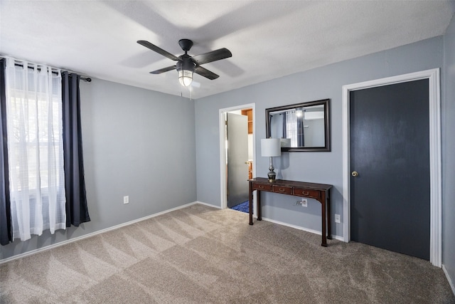 unfurnished bedroom featuring carpet and ceiling fan