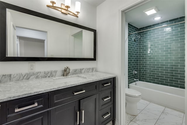 full bathroom featuring vanity, toilet, and tiled shower / bath