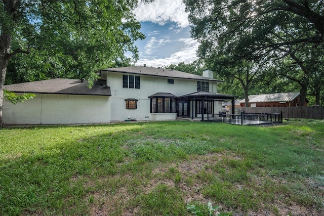 rear view of house featuring a yard and a patio area