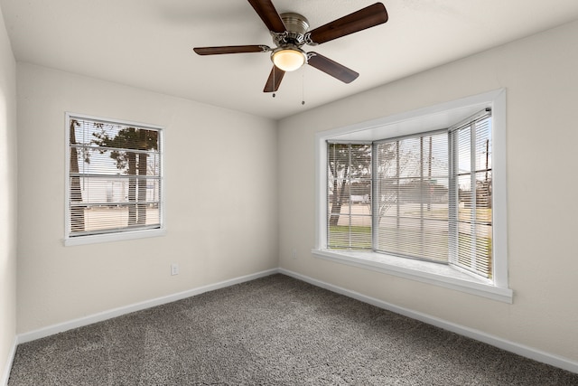 carpeted spare room with ceiling fan