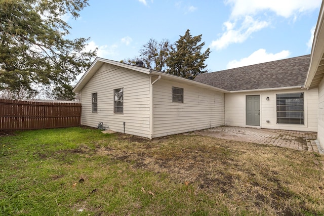 back of property featuring a yard and a patio