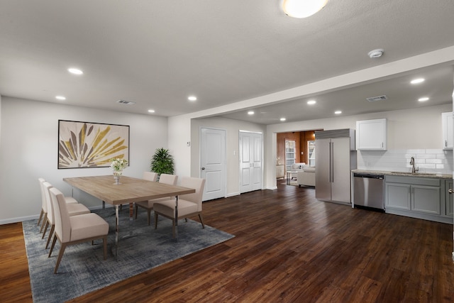 dining space featuring sink and dark hardwood / wood-style floors