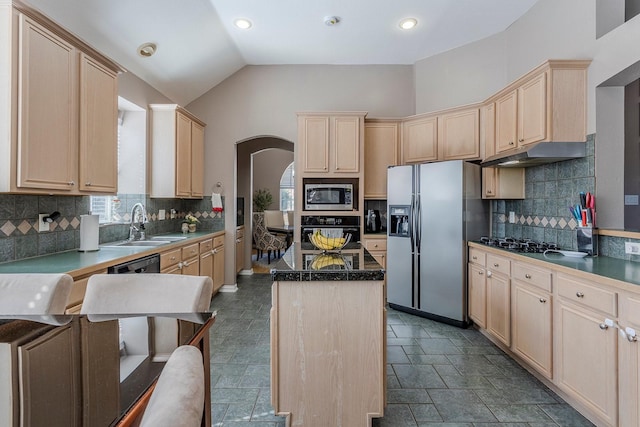 kitchen featuring light brown cabinetry, sink, a center island, vaulted ceiling, and black appliances