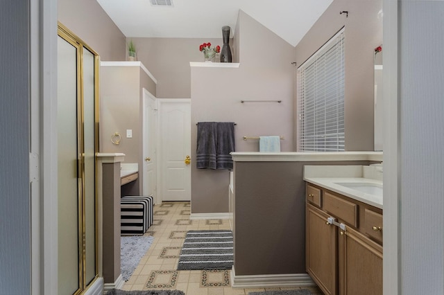 bathroom featuring a shower with door, vanity, and lofted ceiling