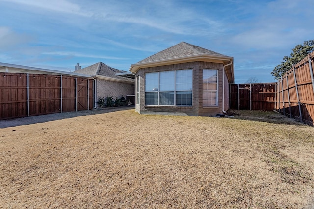 rear view of house featuring a lawn