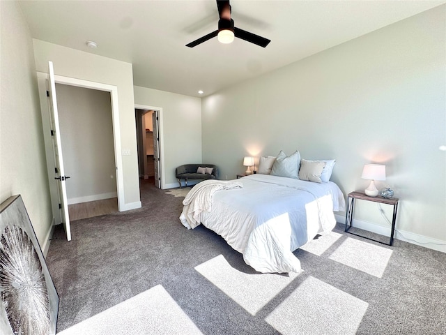 carpeted bedroom with ceiling fan, a closet, and a walk in closet