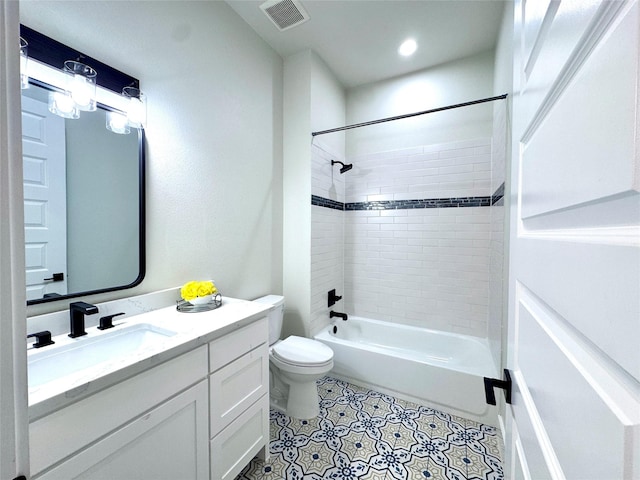 full bathroom featuring tiled shower / bath combo, vanity, toilet, and tile patterned floors