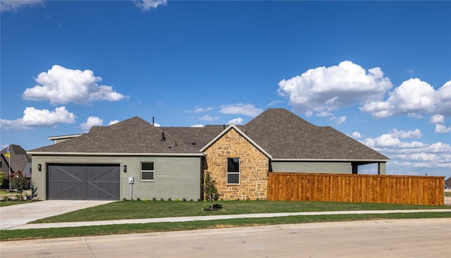 view of front of home with a front lawn and a garage