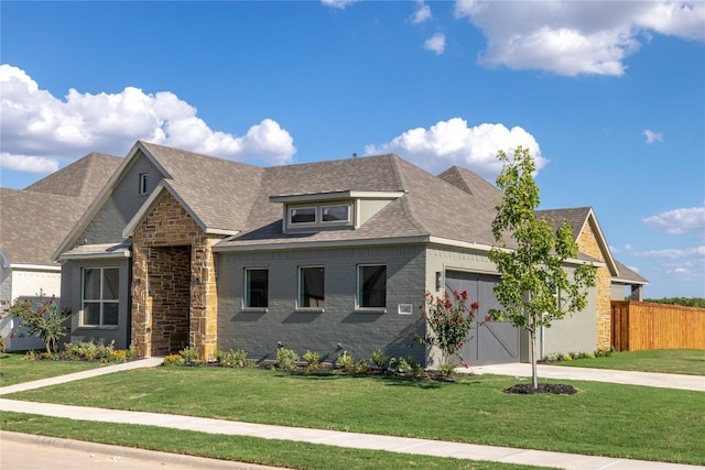 view of front of home with a front yard and a garage