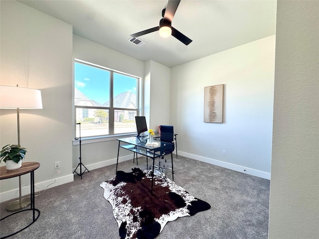 carpeted office space featuring ceiling fan