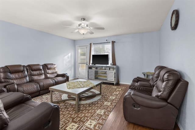 living room with dark hardwood / wood-style flooring and ceiling fan