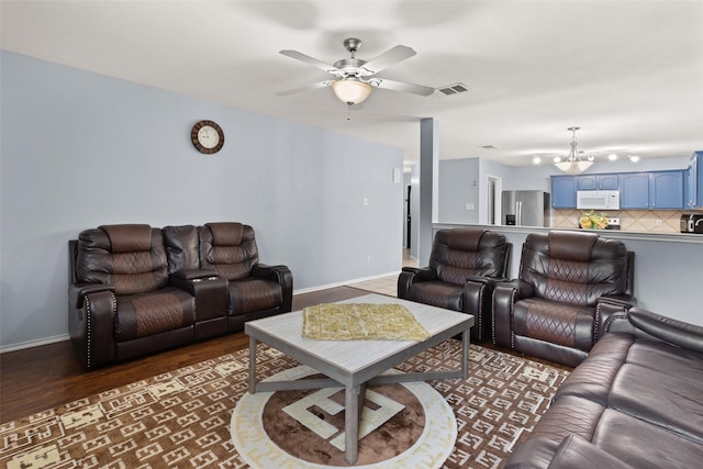 living room featuring dark hardwood / wood-style flooring and ceiling fan