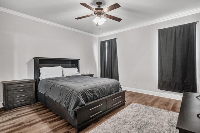 bedroom with ornamental molding, dark hardwood / wood-style floors, ceiling fan, and ensuite bath