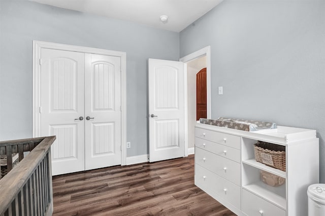 bedroom featuring dark hardwood / wood-style floors and a closet