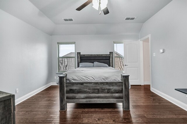 bedroom featuring vaulted ceiling, ensuite bathroom, ceiling fan, and dark hardwood / wood-style flooring