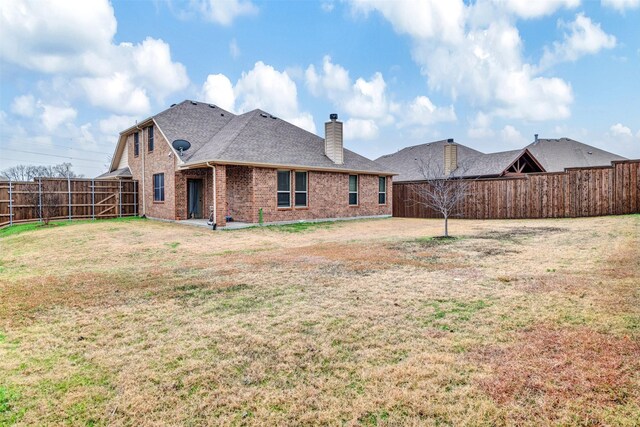 rear view of property with central AC unit and a lawn