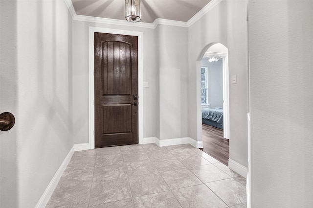 entryway featuring crown molding and light tile patterned flooring