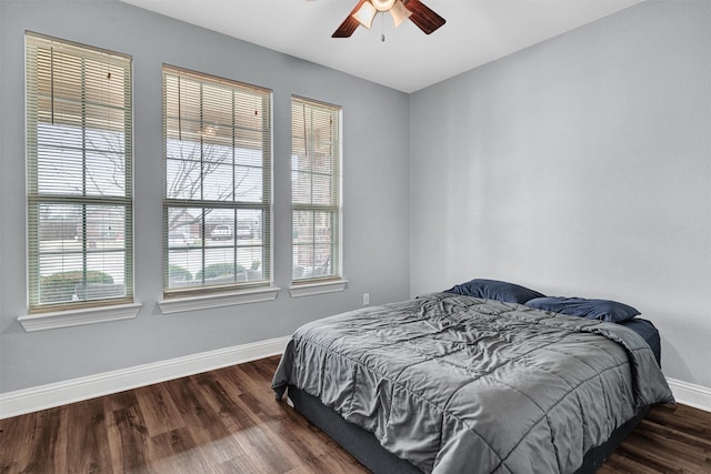 bedroom with dark wood-type flooring and ceiling fan