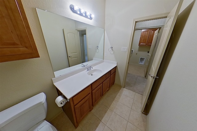 bathroom featuring tile patterned flooring, vanity, and toilet