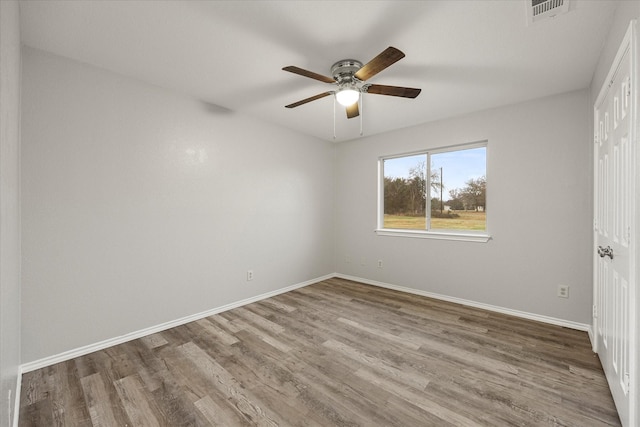 empty room with wood-type flooring and ceiling fan