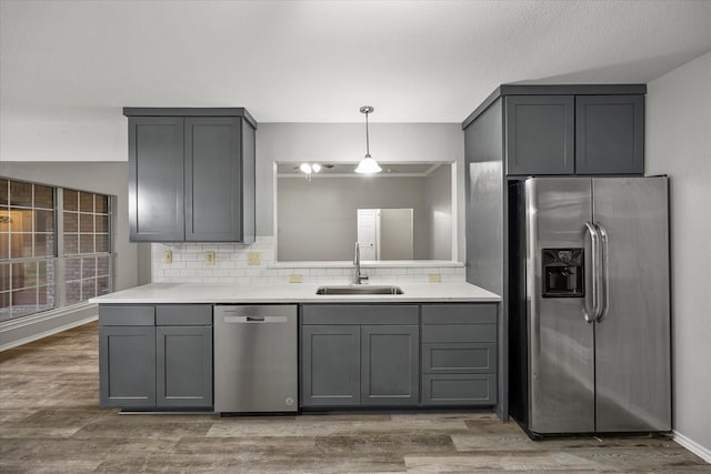 kitchen featuring appliances with stainless steel finishes, sink, and gray cabinetry