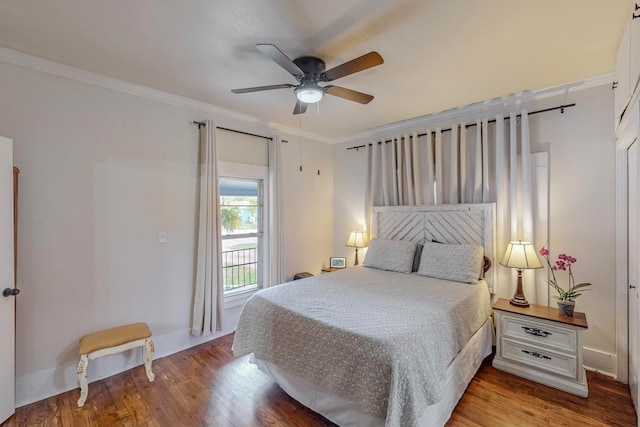 bedroom with crown molding, light hardwood / wood-style flooring, and ceiling fan