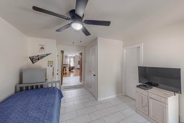 tiled bedroom with ceiling fan