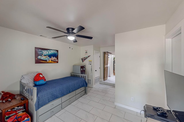 tiled bedroom featuring ceiling fan