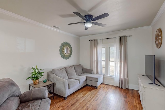 living room with ornamental molding, ceiling fan, and light hardwood / wood-style flooring