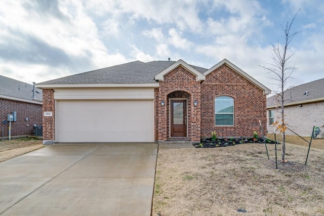 ranch-style house with a garage and central AC unit