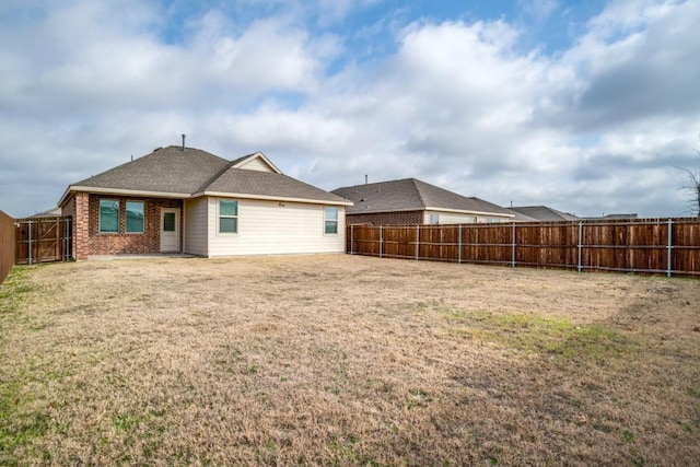 back of property featuring a lawn