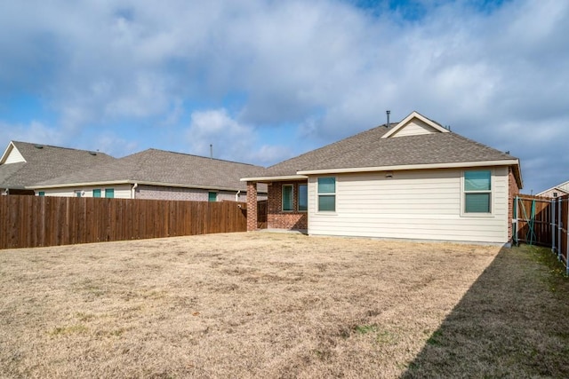 back of house with a lawn