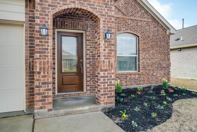 doorway to property with a garage