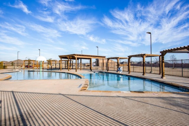 view of pool with a pergola and a patio