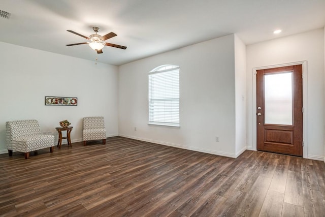 unfurnished room featuring ceiling fan and dark hardwood / wood-style flooring